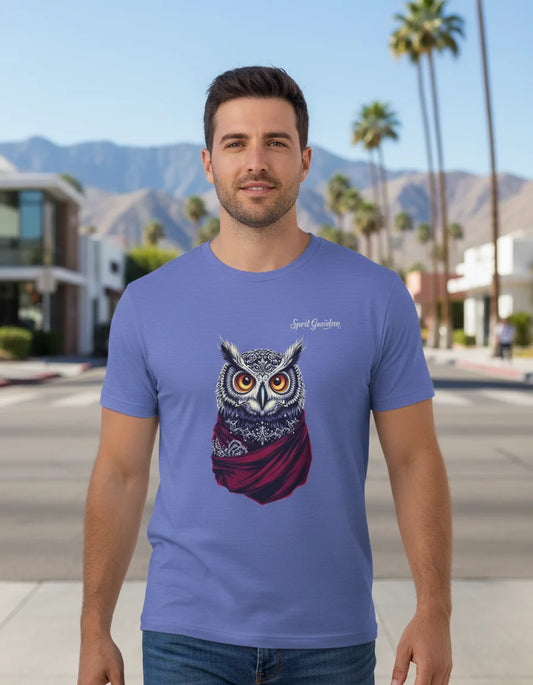 Man wearing a blue t-shirt with an owl design in a city street setting