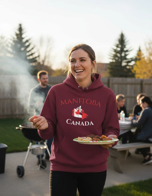 Man wearing a hoodie with 'Manitoba Canada' text sitting at a diner table with a plate of food.