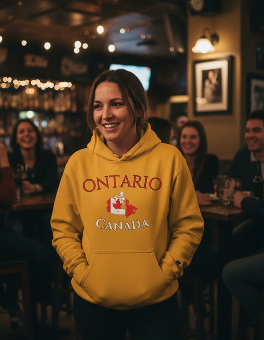 Person wearing a yellow hoodie with 'Ontario Canada' text in a pub setting