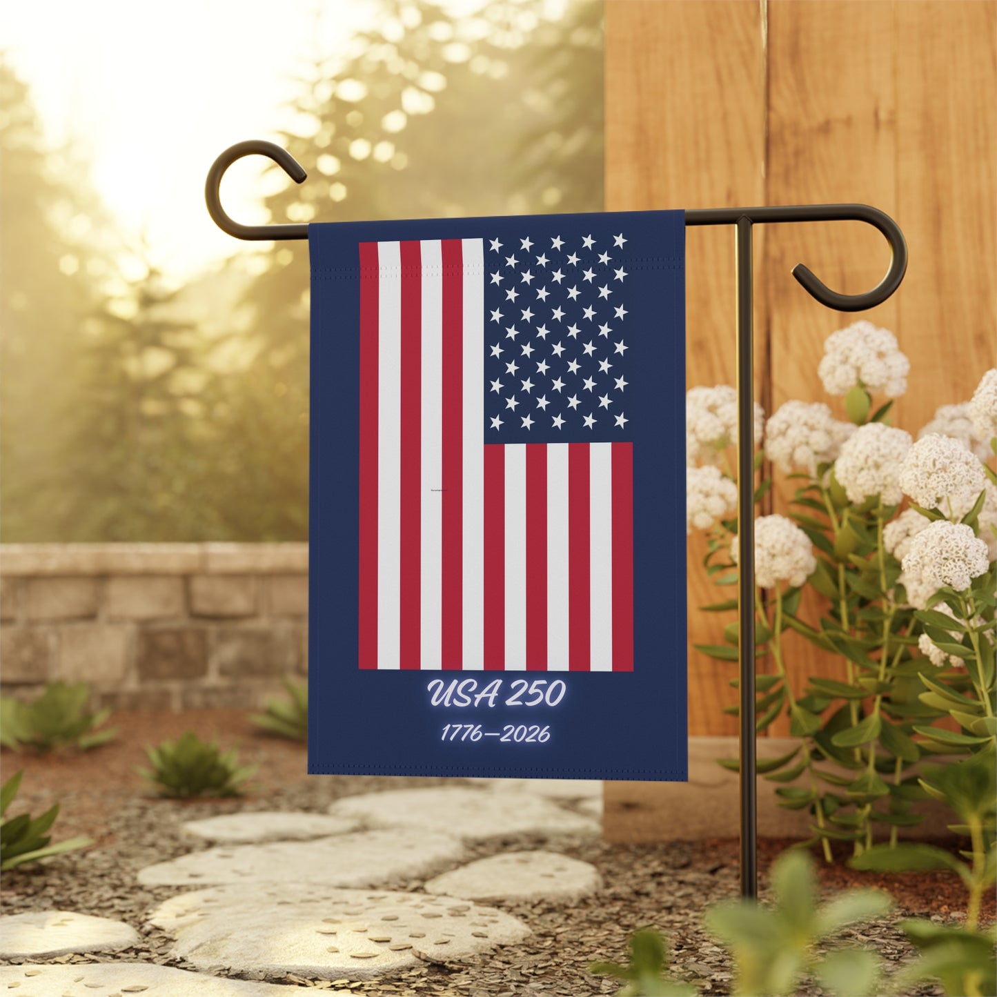 American flag garden flag with 'USA 250' text on a stand outdoors.
