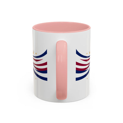 White mug with pink handle and interior, featuring blue and red abstract designs on a white background.