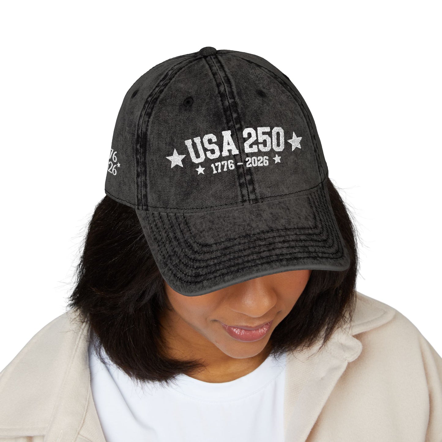 Person wearing a black cap with 'USA 250' text on a white background