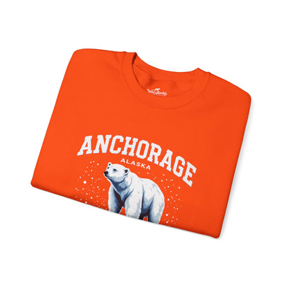 Folded orange t-shirt with a polar bear and 'Anchorage Alaska' text on a white background