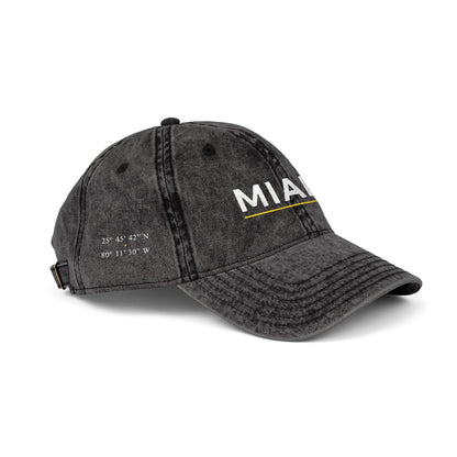 Black denim cap with 'abio' embroidery on a white background