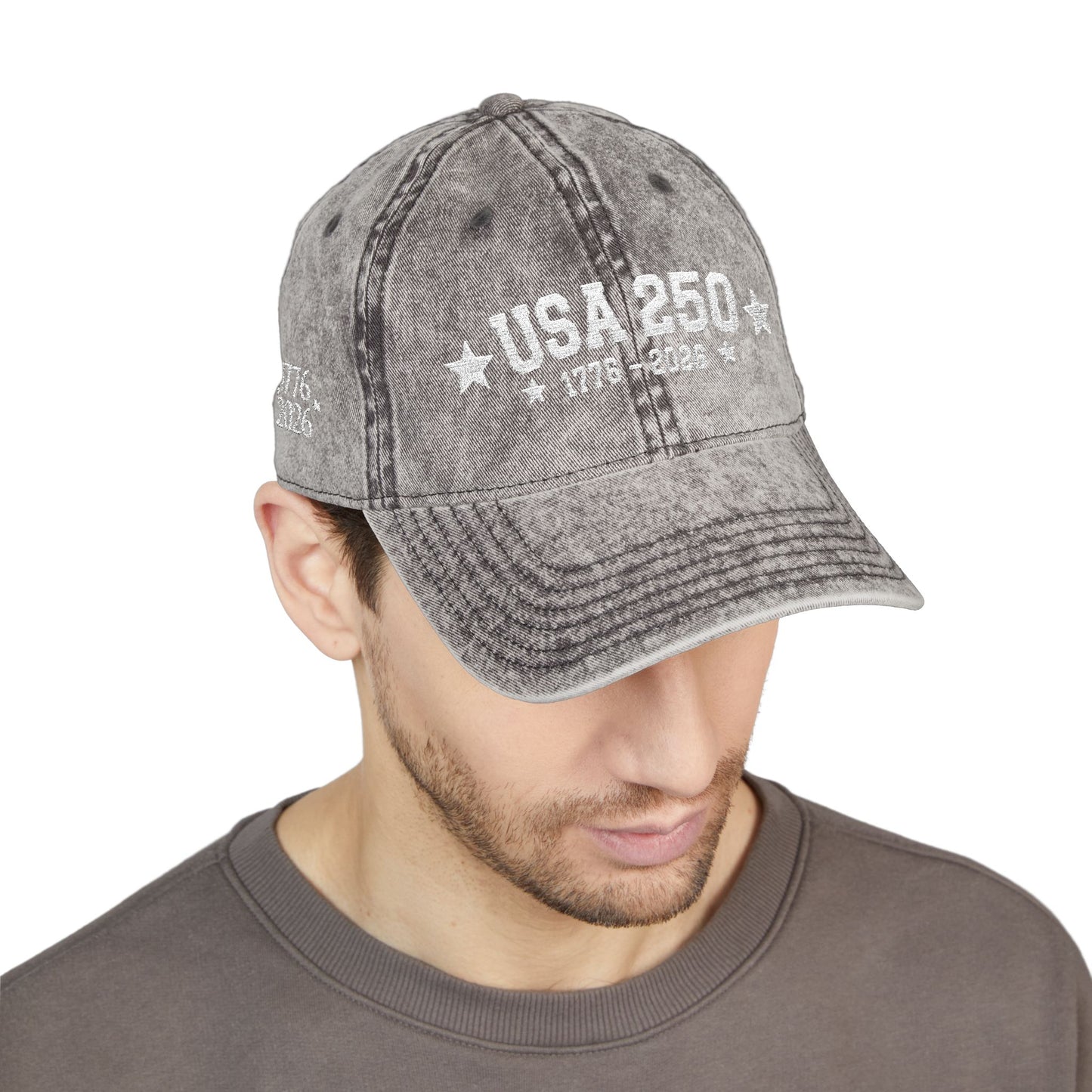 Man wearing a gray distressed cap with 'USA 250' text on a white background