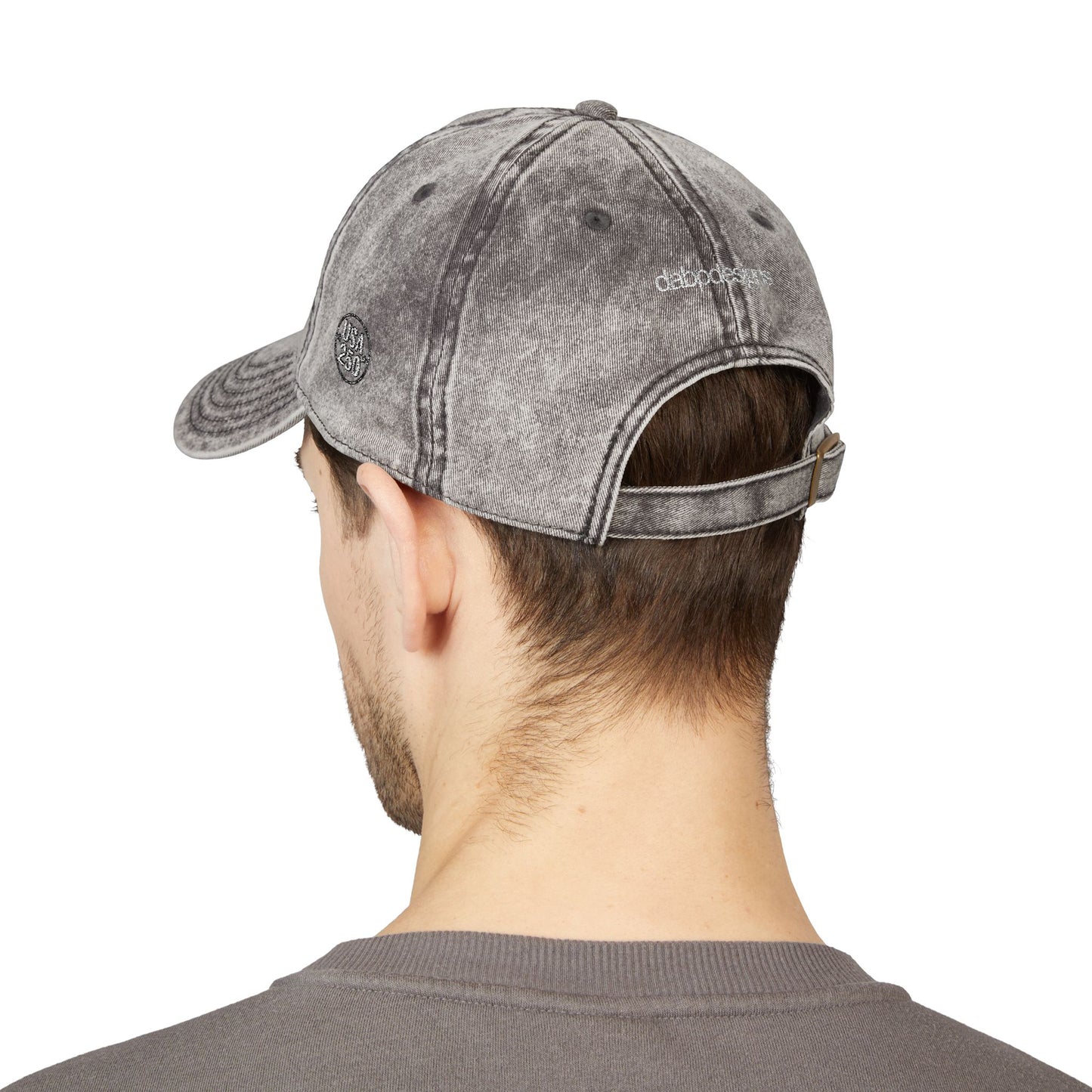 Person wearing a gray denim cap from behind on a white background