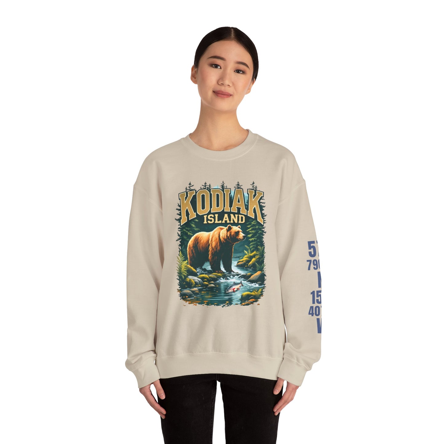 Person wearing a beige sweatshirt with a bear graphic and 'Kodiak Island' text on a white background