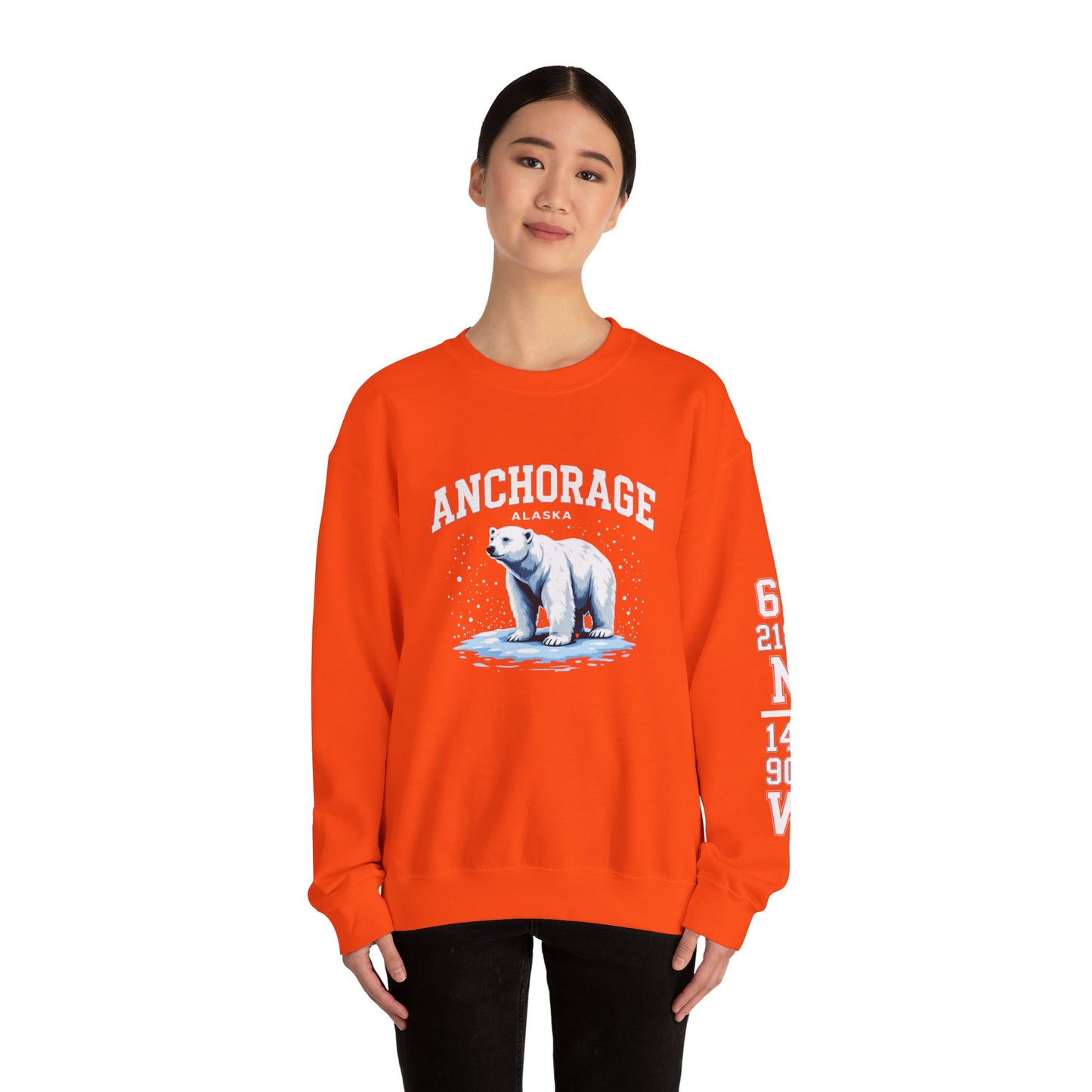 Person wearing an orange sweatshirt with a polar bear graphic and 'Anchorage' text on a white background