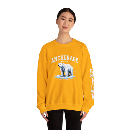 Person wearing a yellow sweatshirt with a polar bear graphic and 'Anchorage' text on a white background