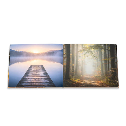 Open book showing two scenic images: a dock by a lake and a forest with fog.