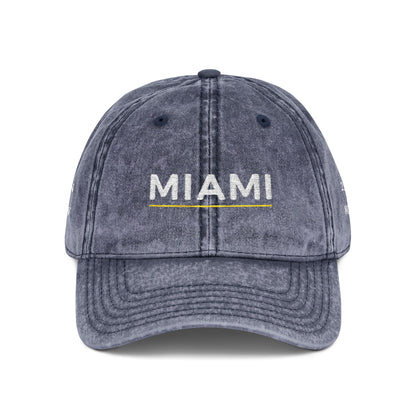 Blue denim cap with 'abide' embroidered on a white background