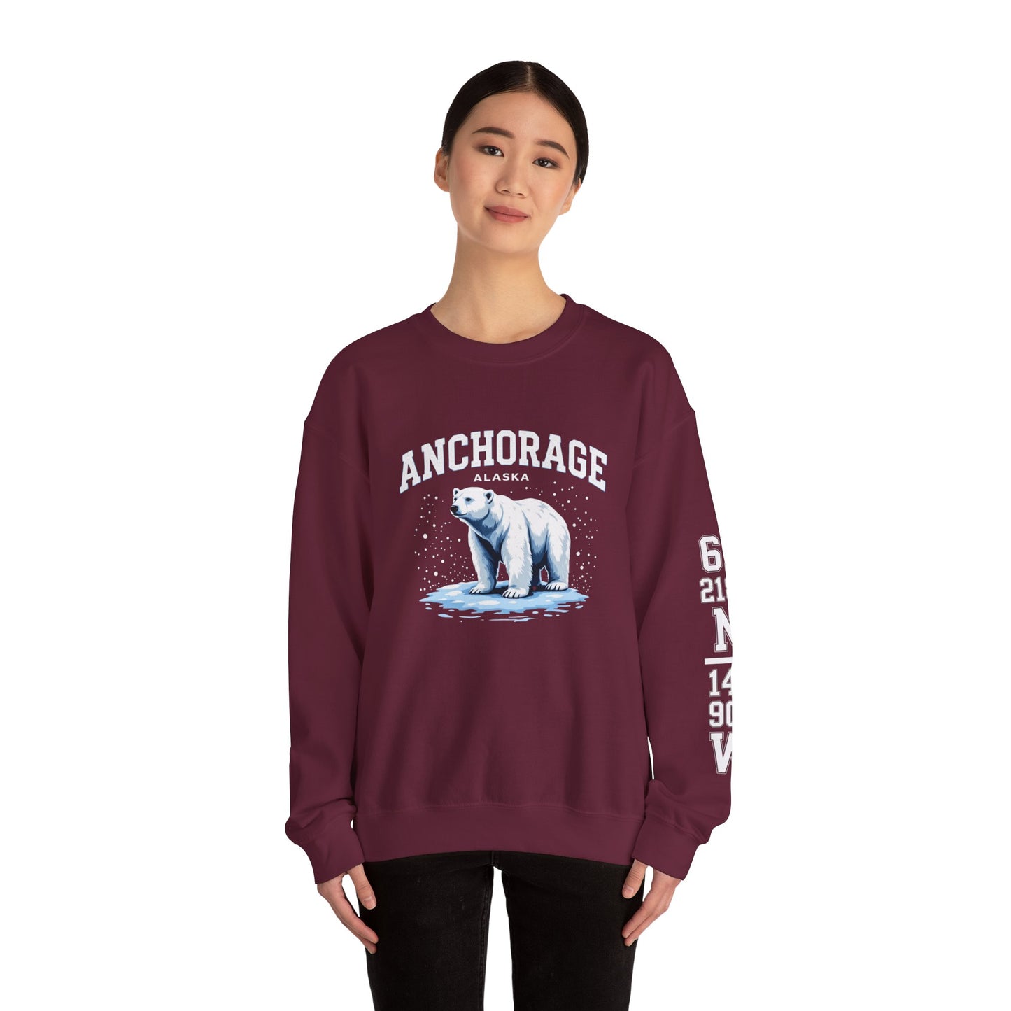 Maroon sweatshirt with polar bear graphic and 'Anchorage Alaska' text worn by a model on a white background