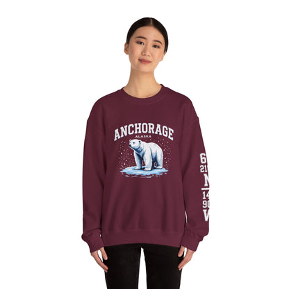 Maroon sweatshirt with polar bear graphic and 'Anchorage Alaska' text worn by a model on a white background