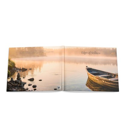 Open book showing a serene lake scene with a boat and sunset.