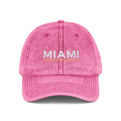 Pink cap with 'abide' embroidered on a white background
