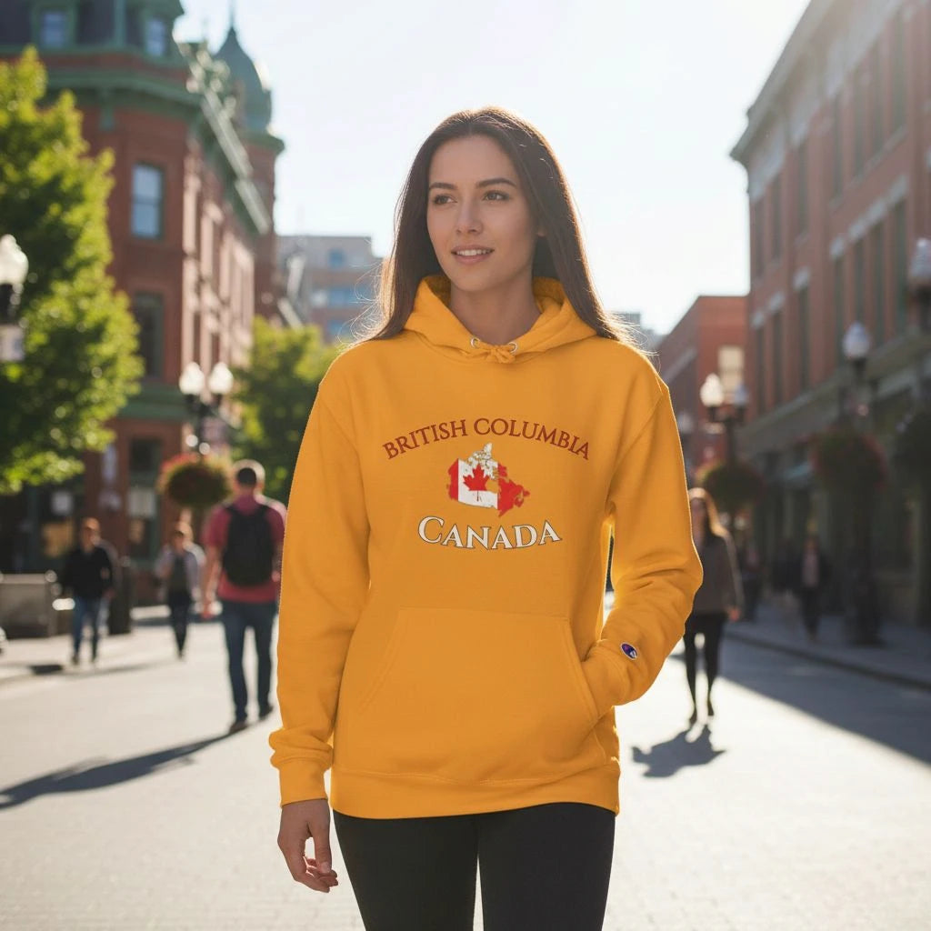 Person wearing a yellow hoodie with 'British Columbia Canada' text and logo on a city street.