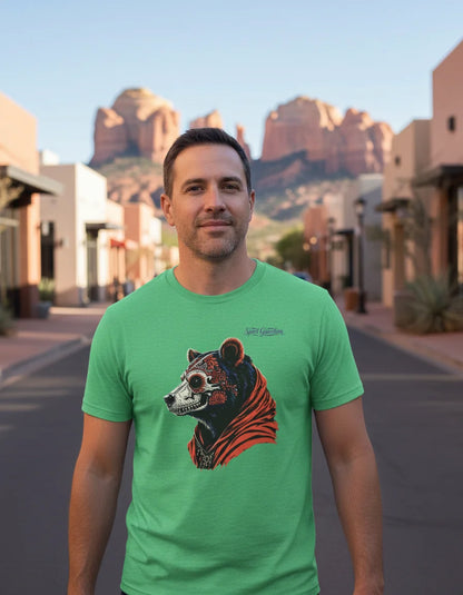 Man wearing a green t-shirt with a bear graphic in a desert town setting