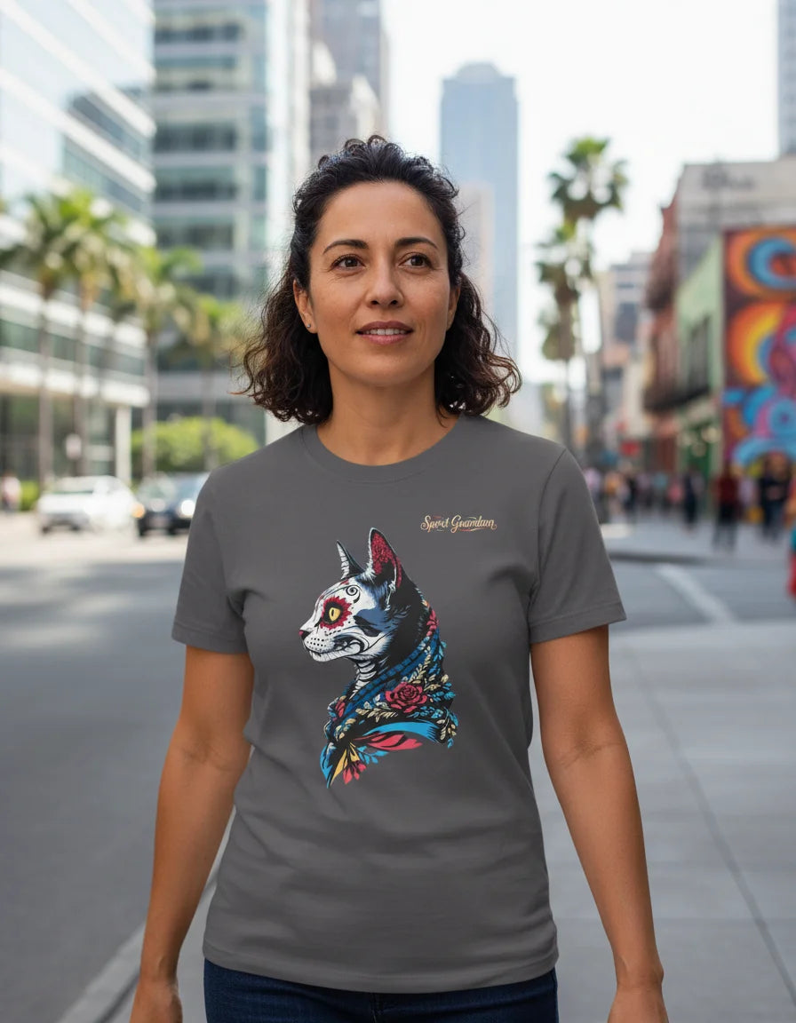 Woman wearing a gray t-shirt with a colorful cat graphic on a city street.