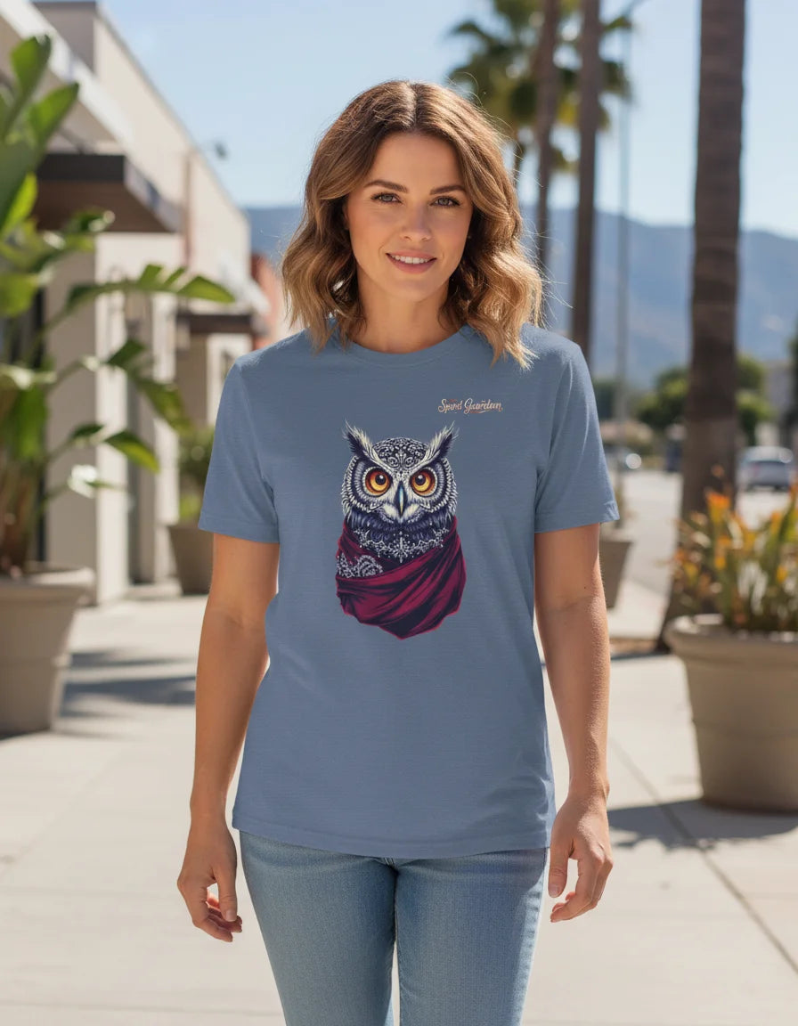 Woman wearing a blue t-shirt with an owl design outdoors.