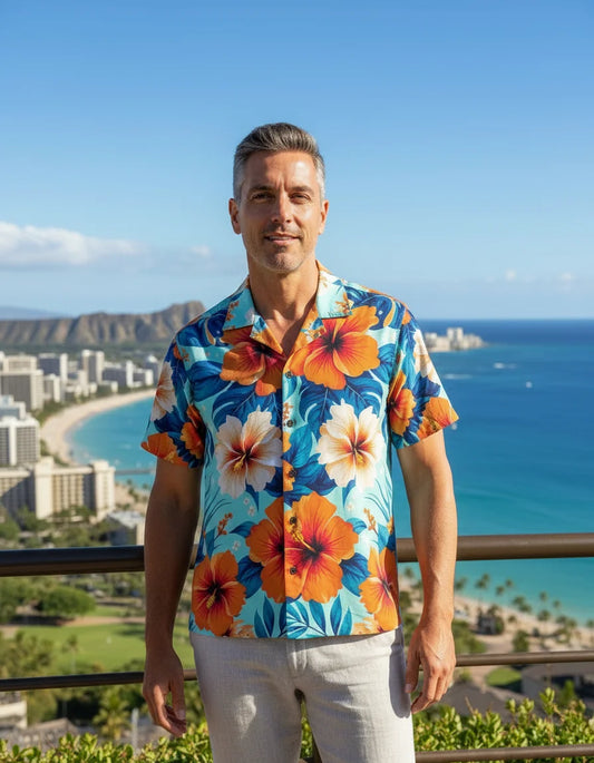 Man wearing a colorful floral shirt with a scenic ocean view in the background