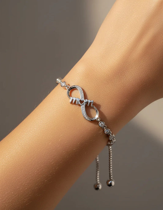 Silver bracelet with a unique design on a wrist against a neutral background