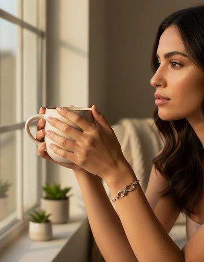 Woman holding a mug by a window with a warm and cozy atmosphere