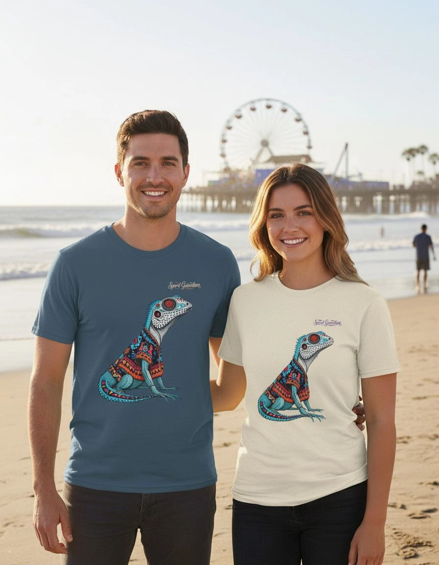 Two people standing on a beach wearing t-shirts with colorful lizard designs.
