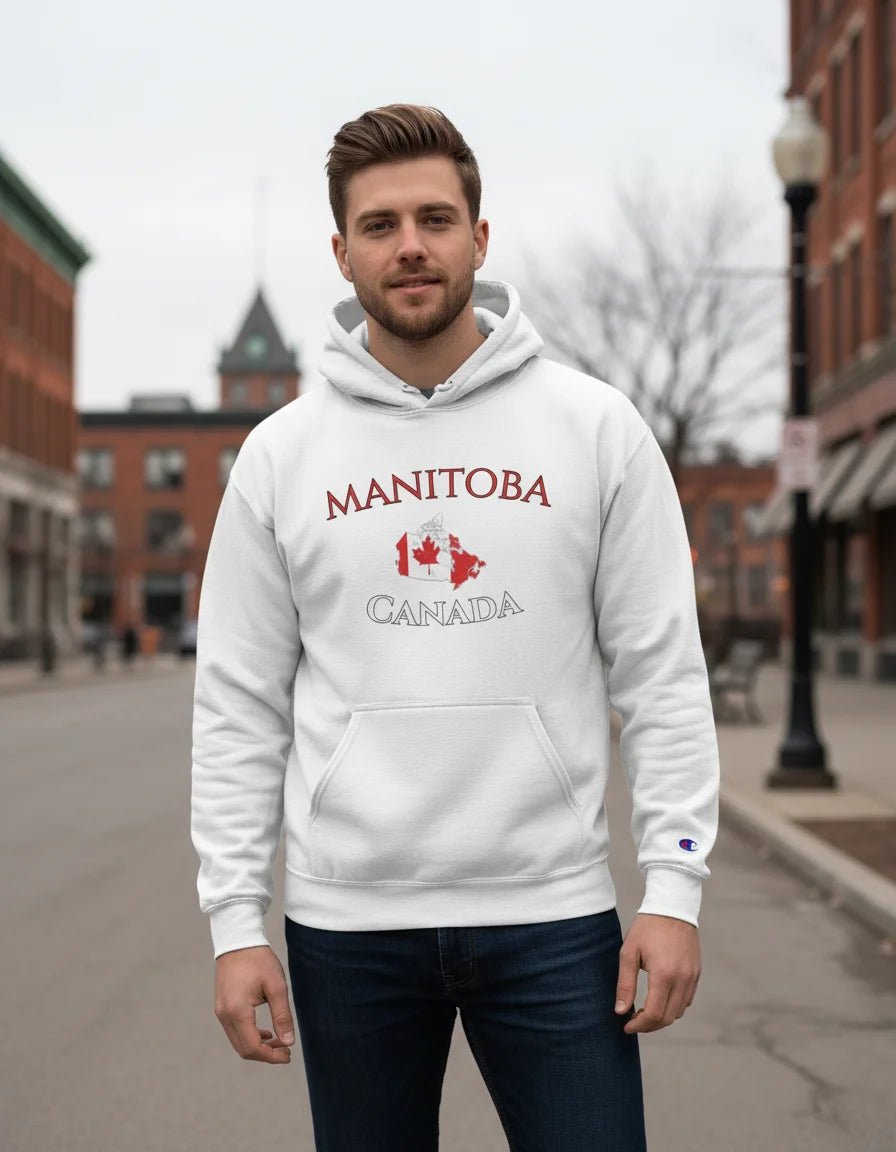 Person wearing a white hoodie with 'Manitoba Canada' text and graphics outdoors.