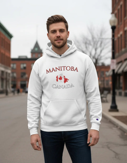 Person wearing a white hoodie with 'Manitoba Canada' text and graphics outdoors.