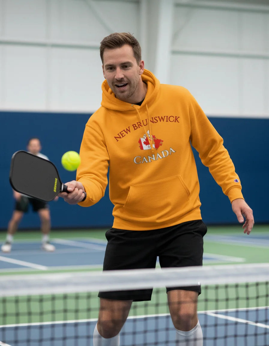 Person wearing a blue hoodie with 'New Brunswick Canada' text and logo outdoors.