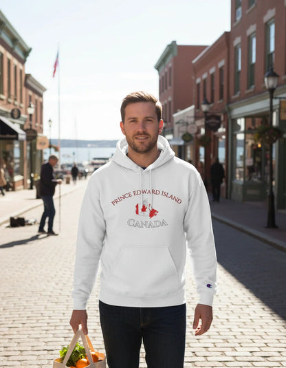 Man wearing a white hoodie with 'Prince Edward Island Canada' text and maple leaf design on a city street.