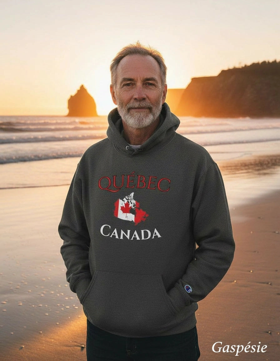 Man wearing a Québec Canada hoodie on a beach at sunset