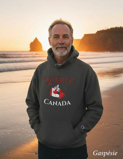 Man wearing a Québec Canada hoodie on a beach at sunset