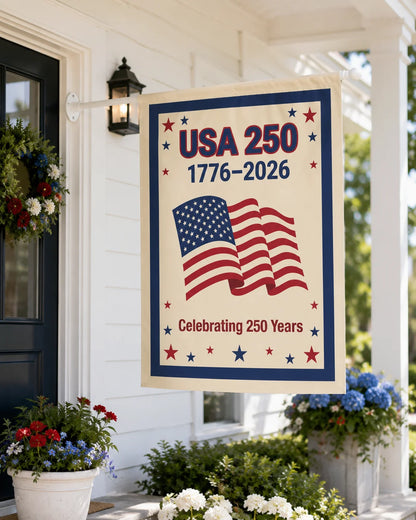 Decorative banner celebrating USA 250th anniversary on a porch with flowers and a wreath.