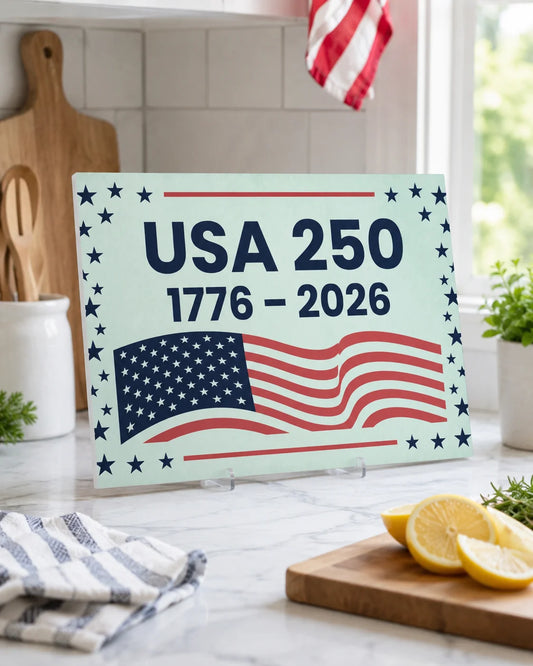 Decorative sign celebrating USA 250th anniversary with an American flag design on a kitchen counter.